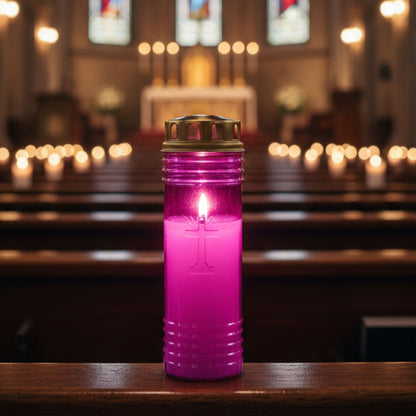 Círio rosa 60 LL aceso, com cruz em relevo e tampa metálica dourada, no interior de uma igreja.